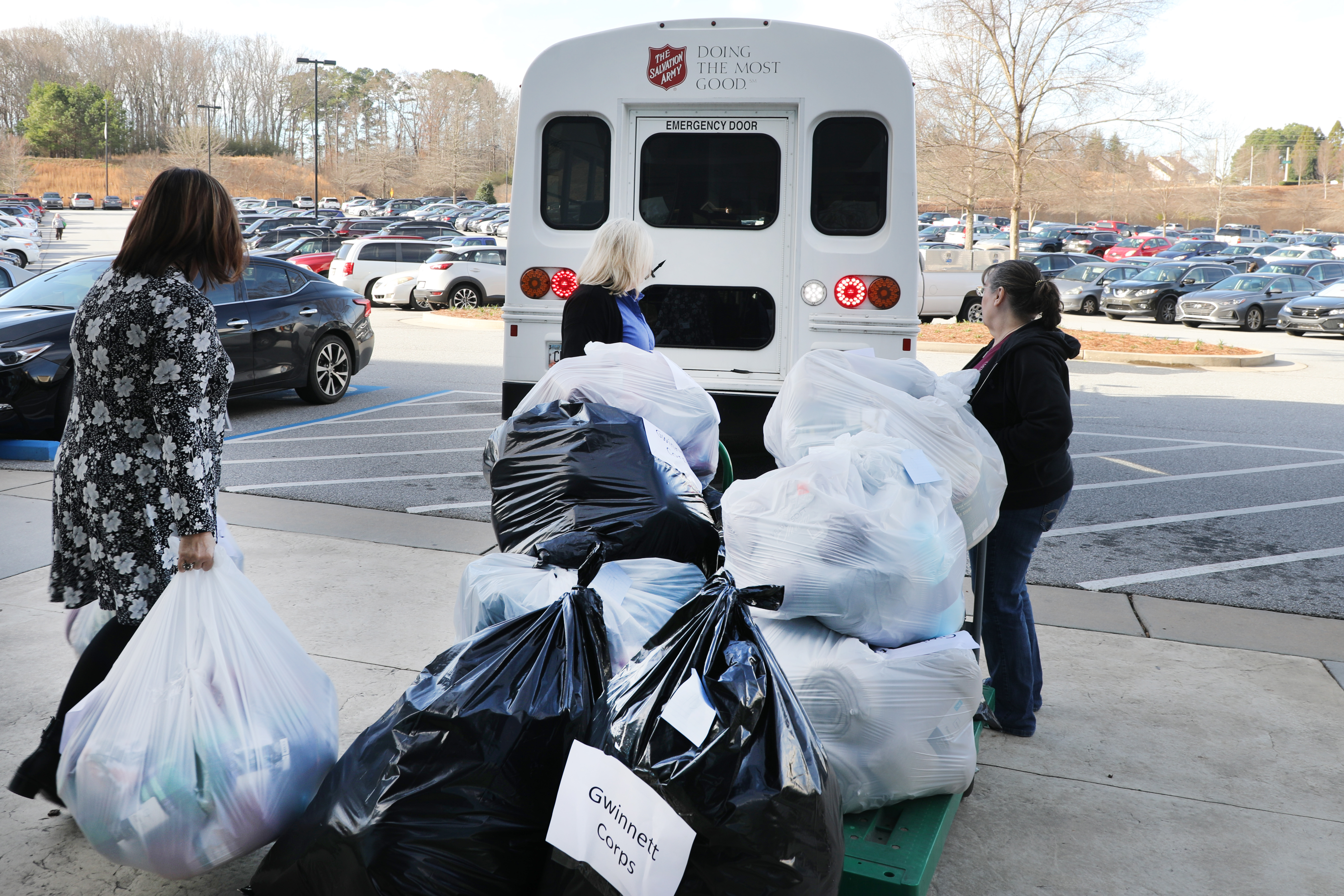 Photo of Primerica employees loading bags of blankets onto truck