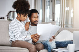 Shot of a young couple going through their paperwork together at home